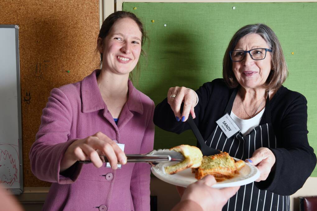 Jessica Harris and Sandy Butterfield serve up lunch at the Harvest Ministry of Food meals program. Picture: Kate Healy 