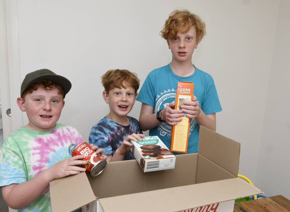 GIVING: Eight-year-old Hamish Pollard, six-year-old Fletcher Pollard and 11-year-old William Pollard are looking forward to packing their Reverse Advent Calendar box. Picture: Lachlan Bence 
