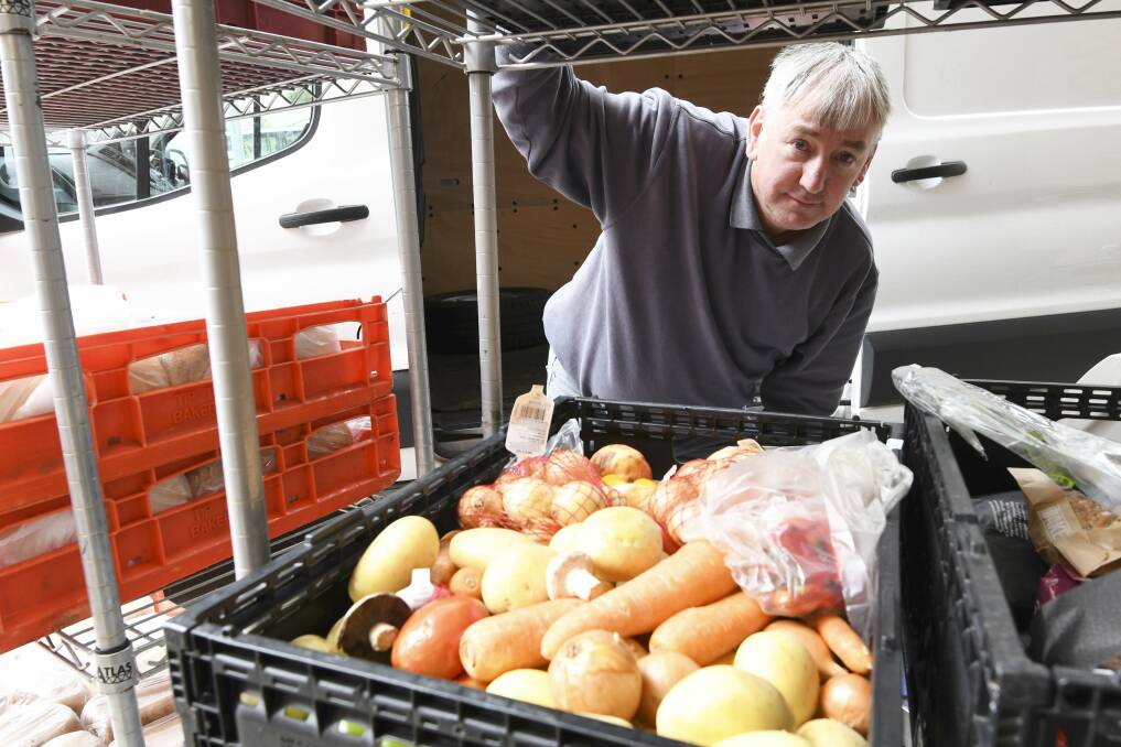 FOOD RELIEF: Salvation Army Ballarat volunteer Robert Miller unloads food from a truck to be distributed to those in need as part of the grocery box program. Picture: Lachlan Bence 