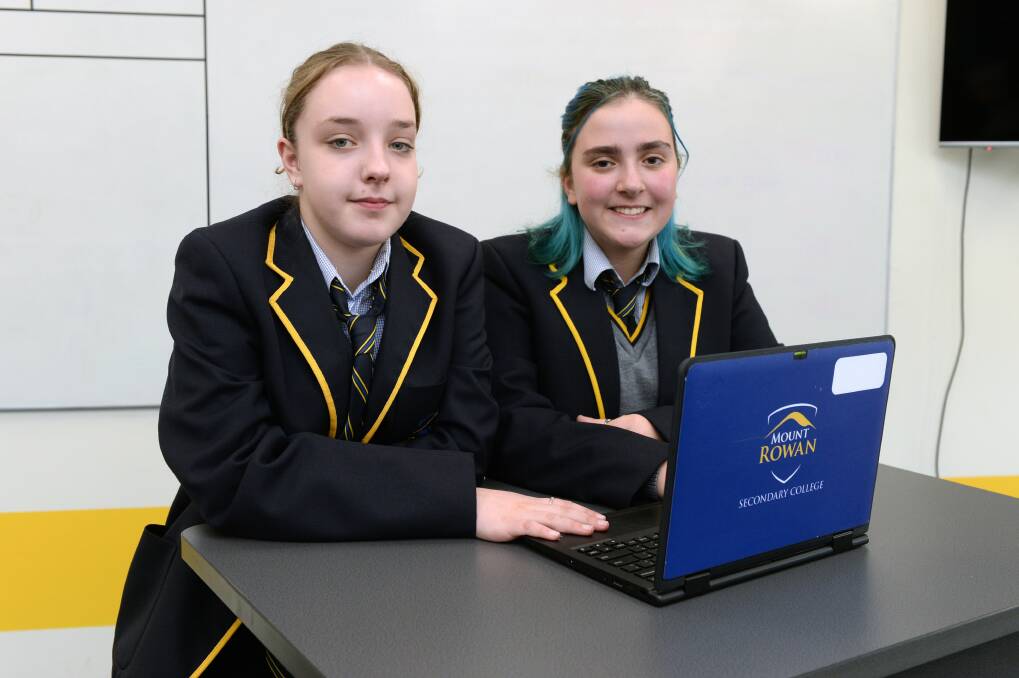 TEACHING TECH: Mount Rowan Secondary College Year 8 students Ella Evans and Violet Hearnshaw are helping elderly with technology skills. Picture: Kate Healy 