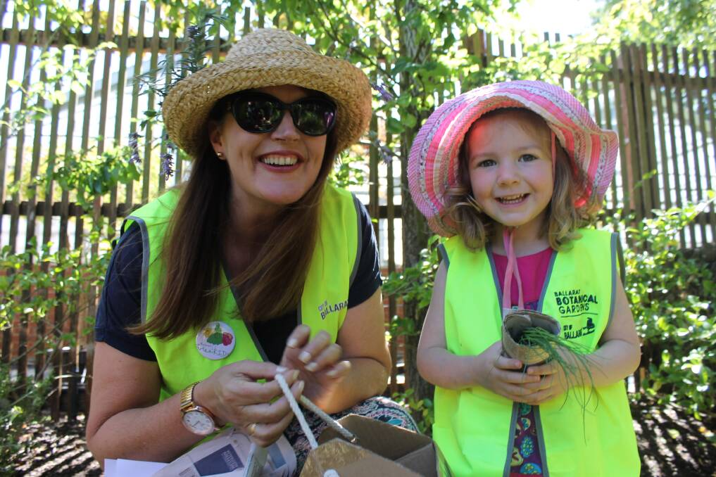 HELPING HAND: BotaniKIDS volunteer Fiona Walsh helps Mollie Arnts, 3 plant herbs a the Ballarat Botanical Gardens. Picture: Rochelle Kirkham 