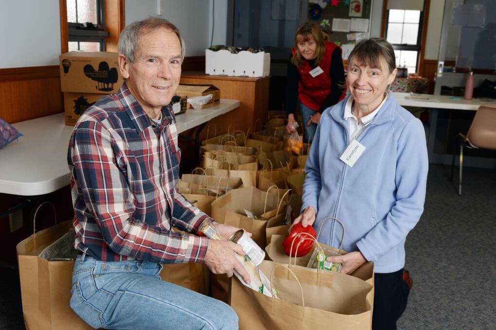 GROCERY SERVICE: Seventh Day Adventist Church Good Samaritan Centre volunteers David Warland, Carolyn Swanton and Carolynn Carnegie create bags of groceries of fresh food and staples to sell for $5 to those in need. The service runs in Ballarat and Maryborough. Picture: Kate Healy 