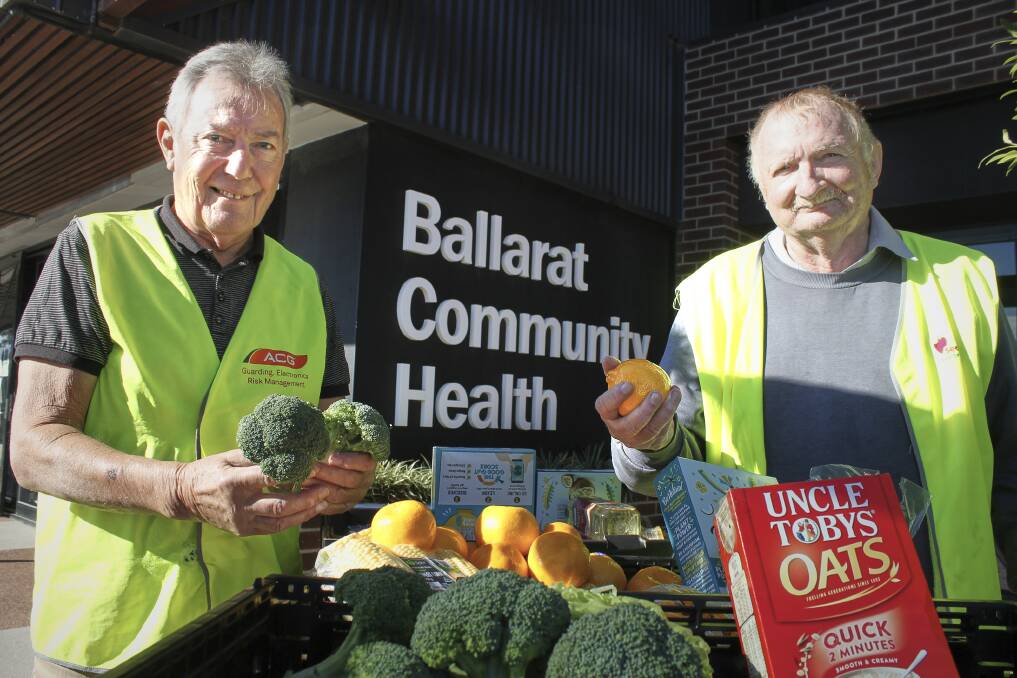 RESCUE FOOD: Secondbite volunteers Tony Saunders and Michael Quarrell deliver rescued food to Ballarat Community Health. Picture: Rochelle Kirkham 