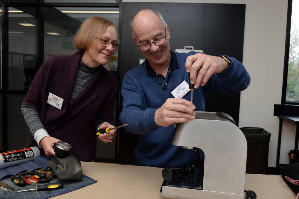 REPAIR: Karen Ellis and and Danny Ellis from Mend It Australia fix a coffee machine at the Ballarat Repair Cafe, a small scale version of a circular economy. Picture: Kate Healy 