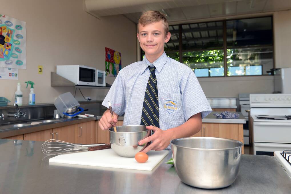 SERVICE: Mount Rowan student Xavier, 14, has been spending extra time in the kitchen at school since discovering a passion for cooking. He donated a large lasagne to the Soup Bus on Wednesday. Picture: Kate Healy