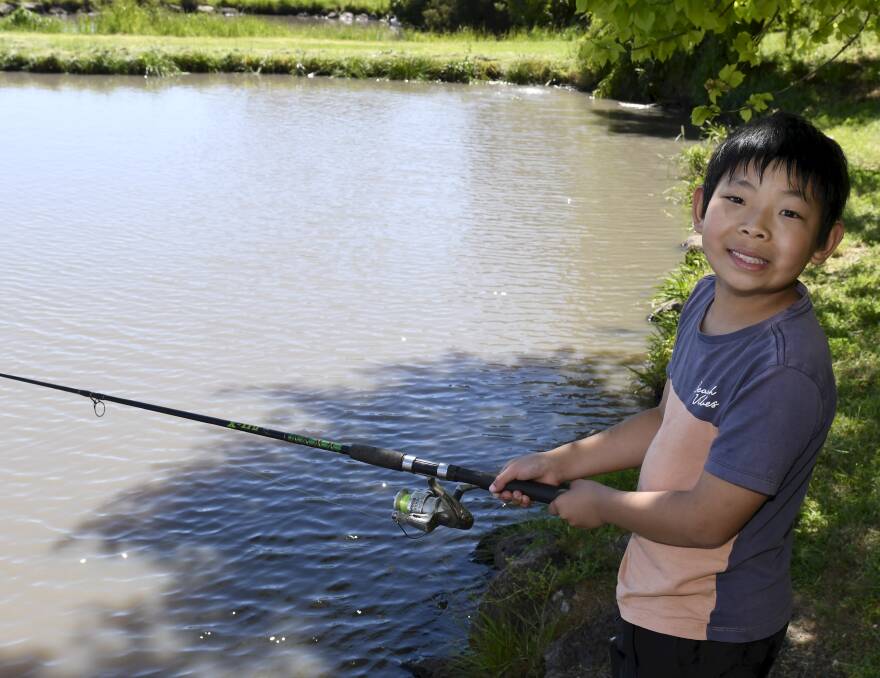 Nine-year-old Ethan Wang fishing at Tuki Trout Farm. 