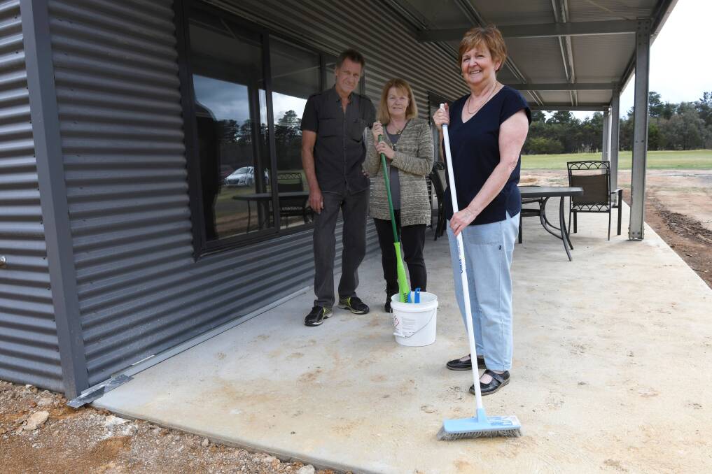 COMMUNITY: Trevor Hart, Donna Hart and Joan Smith help prepare the new Clarendon Community Hub for use. Picture: Lachlan Bence 