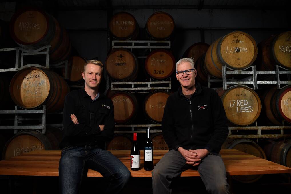 PASSION: Lemlex Joinery owner Johan Debast and Michael Unwin from Michael Unwin Wines sit on a table Mr Debast made in the Michael Unwin Wines shed. Picture: Adam Trafford 
