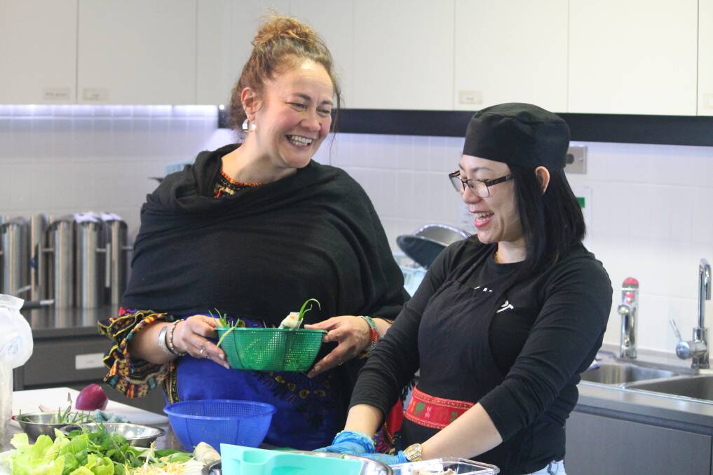 FAMILY: A Pot of Courage founder and co-ordinator Shiree Pilkinton helps Dung Nguyen in the kitchen.