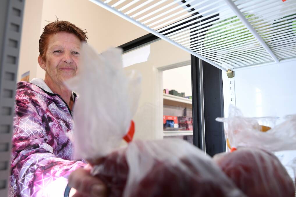 PROVIDING RELIEF: Salvation Army Ballarat volunteer Jenny Giles stocks the fridge with fresh food as part of the supermarket for emergency food relief. She helps clients pack food to take home. Picture: Lachlan Bence 