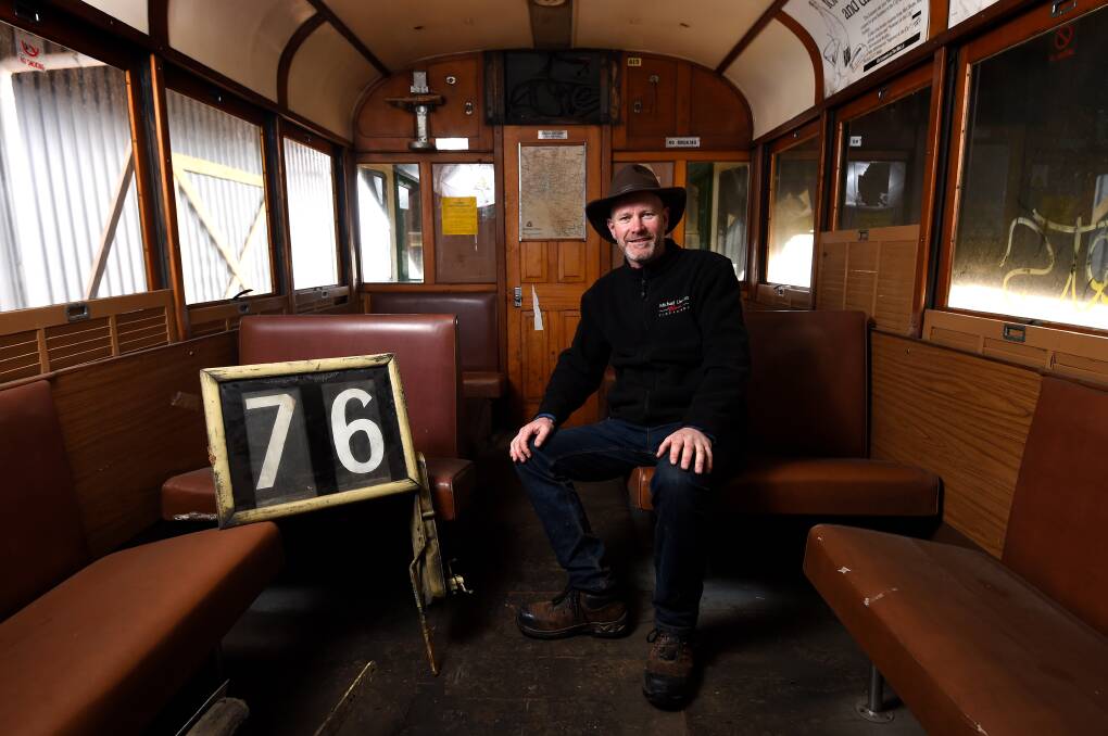 A PIECE OF HISTORY: Winery owner Michael Unwin explores the inside of the historic Melbourne tram. Picture: Adam Trafford 