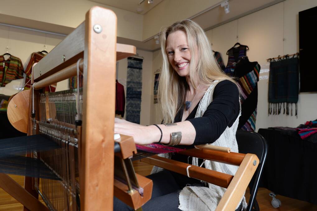  WEAVE: SAORI teacher Prue Simmons weaves a pink based cloth at the Celebration of SAORI exhibition in Clunes. Pictures: Kate Healy