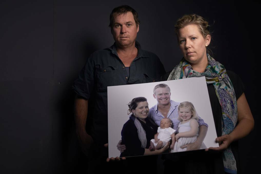 A FATHER LOST: Charlie Howkins' brother Reg and wife Lana Cormie with a family photo a month after the tragic incident. Picture: Luka Kauzlaric 