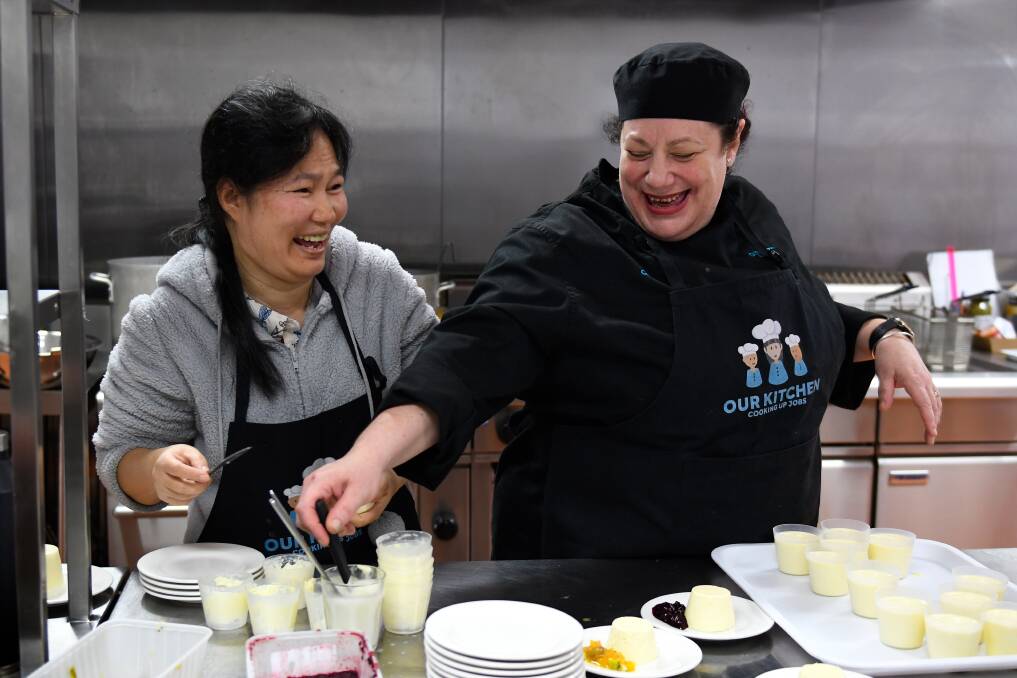 Ballarat Neighbourhood Centre chef and trainer Kate Mirvis (right) prepares dessert with volunteer Goza Lockyear. Picture: Adam Trafford 