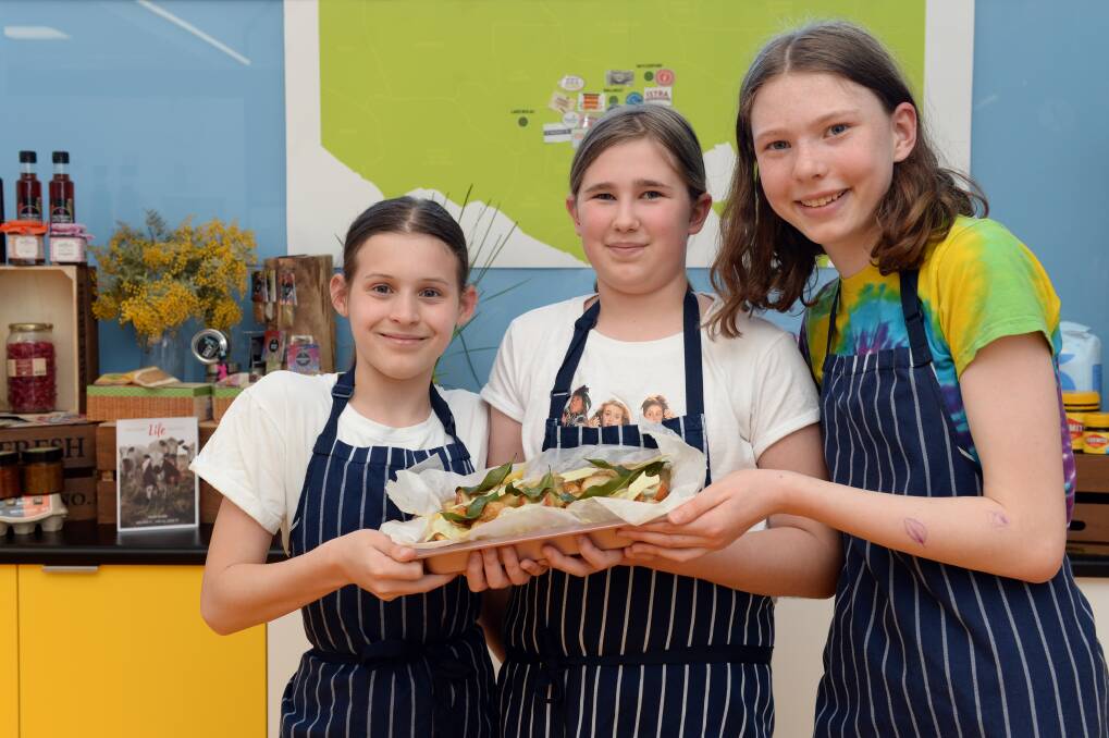 CREATE: Mount Clear College students Emily Micallef, 12, Freya Campbell, 13, and Bethany Opie, 13, developed a lemon myrtle and pear slice. Picture: Kate Healy 