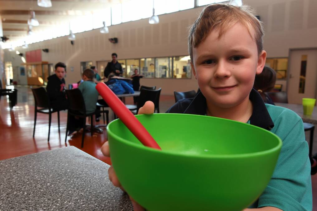 FILLING STOMACHS: 10-year-old Luke finishes his cereal at the Yuille Park Community College breakfast program on Friday. Picture: Lachlan Bence 