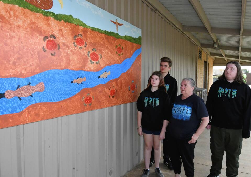 ART MURAL: DOTS Program participants Xavier Cuirn, Kirra Blackburn and Jesse Mackay with artist Janet Curtain. Picture: Lachlan Bence 