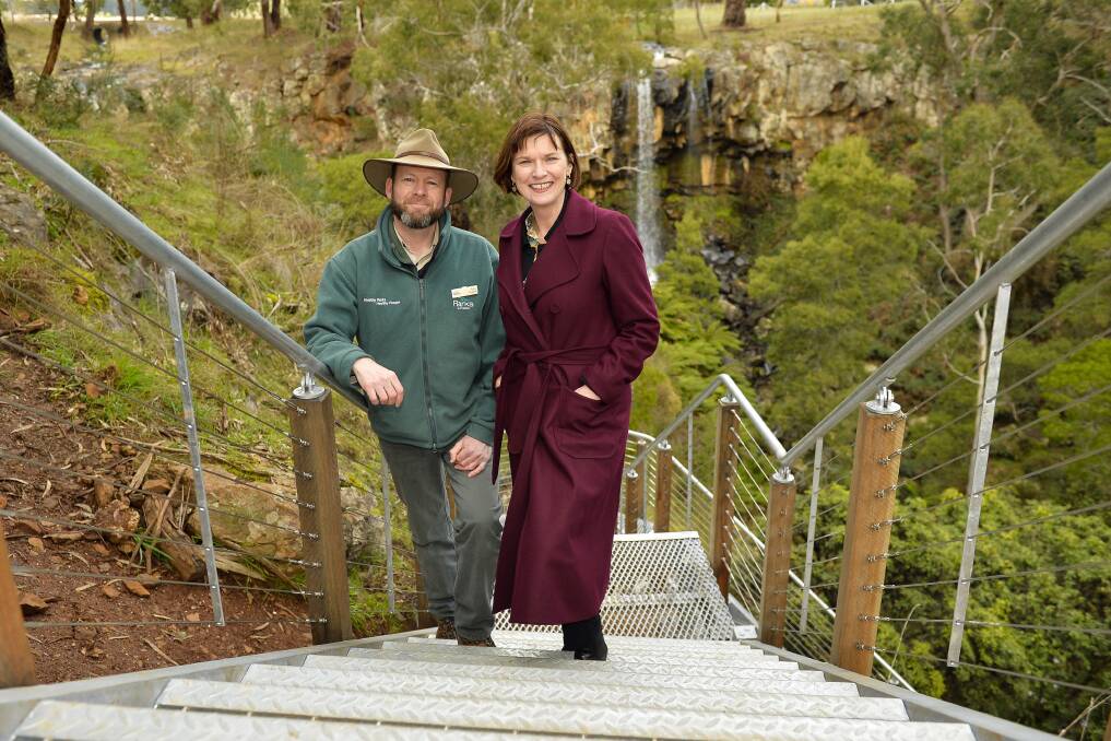 REOPENING: Parks Victoria district manager Tony English and Macedon MP Mary-Anne Thomas take the first steps on the new staircase. Picture: Dylan Burns. 