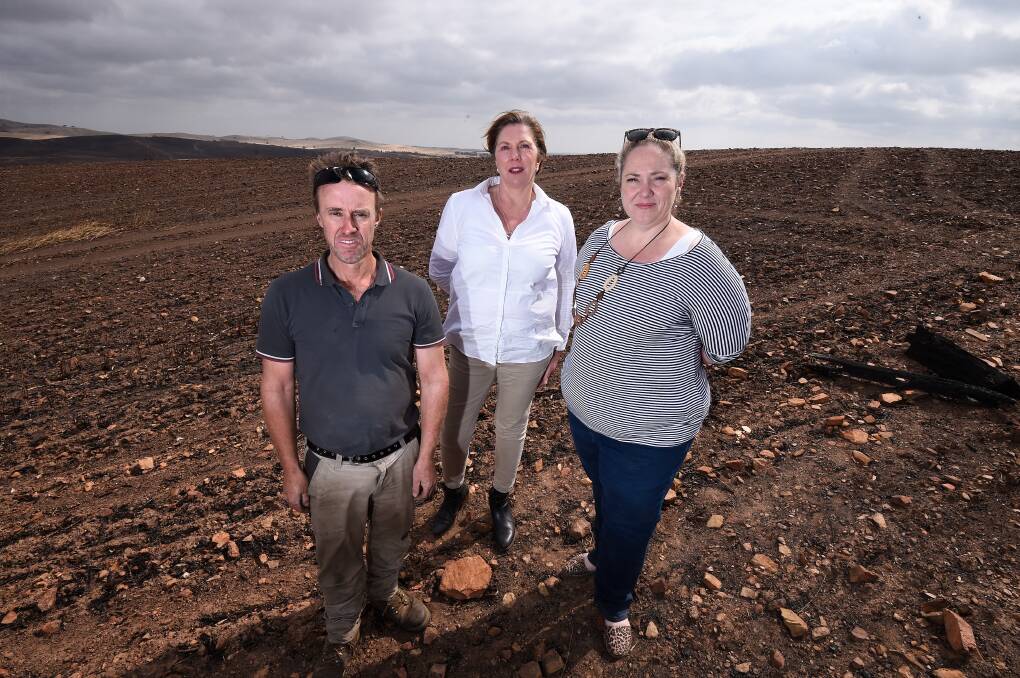 DEVASTATED: Rod McErvale, Ballarat MP Catherine King and Rebecca McErvale on the farm in January, one month after the fire hit. Picture: Adam Trafford 