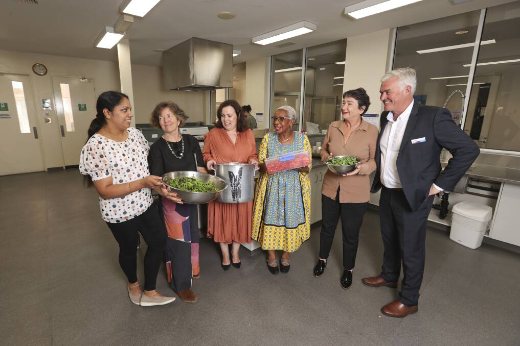 SHARING FOOD: Betty Mathews, Ann Foley, Silvia Renda, Joy Sawiche, Michaela Settle and Graham McMahon at the launch of the new kitchen. Picture: Luke Hemer 