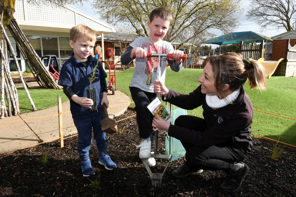 PLANTING TOGETHER: Leigh Catchment Group environmental projects officer Bianca Fammartino helps Rhyce and James plant a tree at Wendouree Children's Centre. Picture: Lachlan Bence 