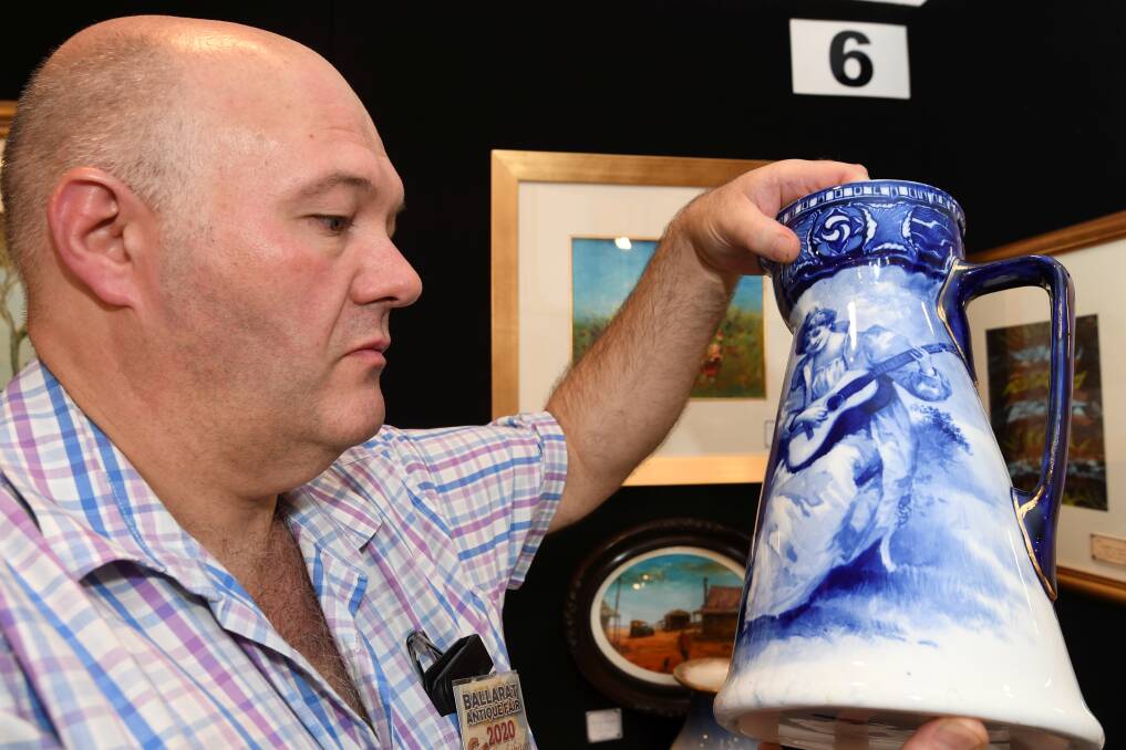 ANTIQUE: Simon Mackley with a Royal Doulton Flow Blue Aubbey pitcher at the Ballarat Antique Fair. 