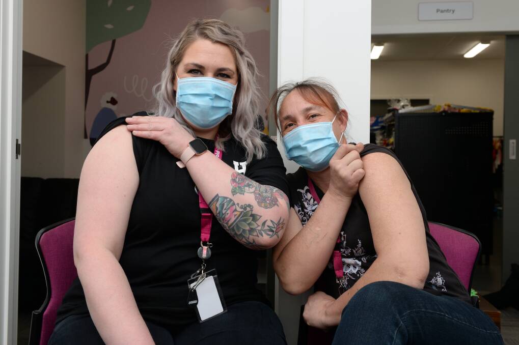 VACCINATED: Uniting Street 2 Home team leader Stacey Park and Uniting client Marina Henning rolled up their sleeves to receive their COVID-19 vaccination. Pictures: Kate Healy 