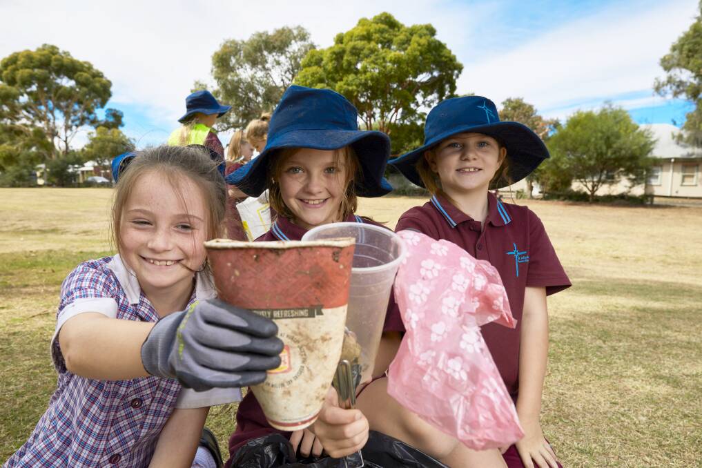 CLEAN UP: Grade three pupils Sophie, Bridi and Bianca from St Alipius Primary School clean up at McKenzie Reserve. Picture: Luka Kauzlaric 