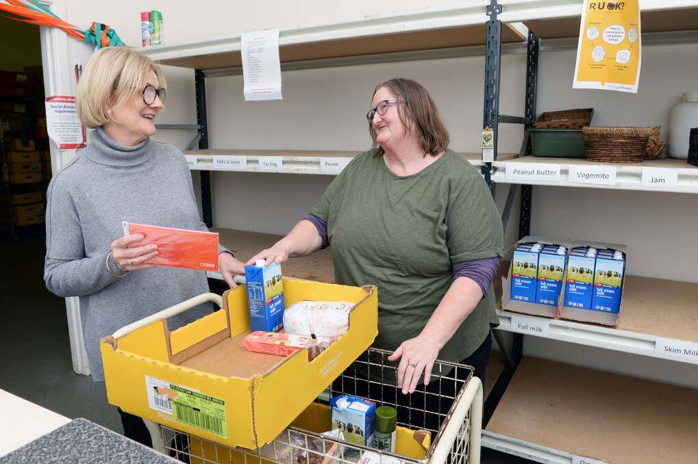 DIRE NEED: Salvation Army Grocery Box volunteers Edna and Tracey work to pack a food hamper for a client, with a Ballarat Foundation grant helping to restock empty shelves. Picture: Kate Healy 