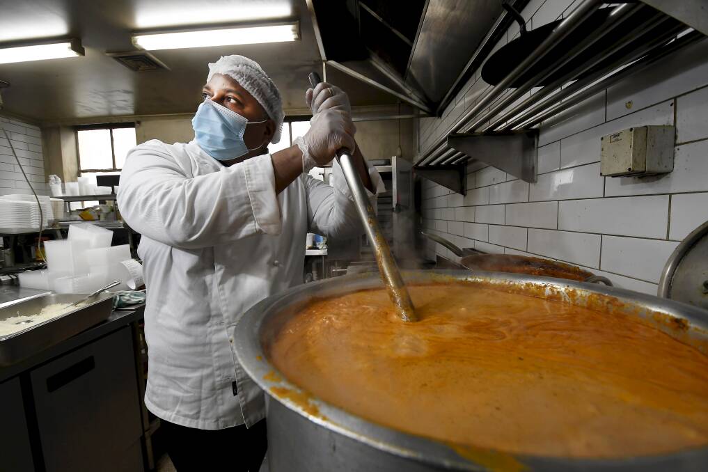 GIVING: Chef Rijo Antony spent hours cooking hundreds of serves of butter chicken on Thursday to give free to members of the community. Picture: Lachlan Bence 