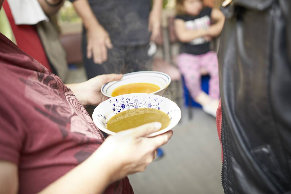 SOUP'S UP: Volunteers serve hot soup to hungry visitors on Saturday. Picture: Luka Kauzlaric