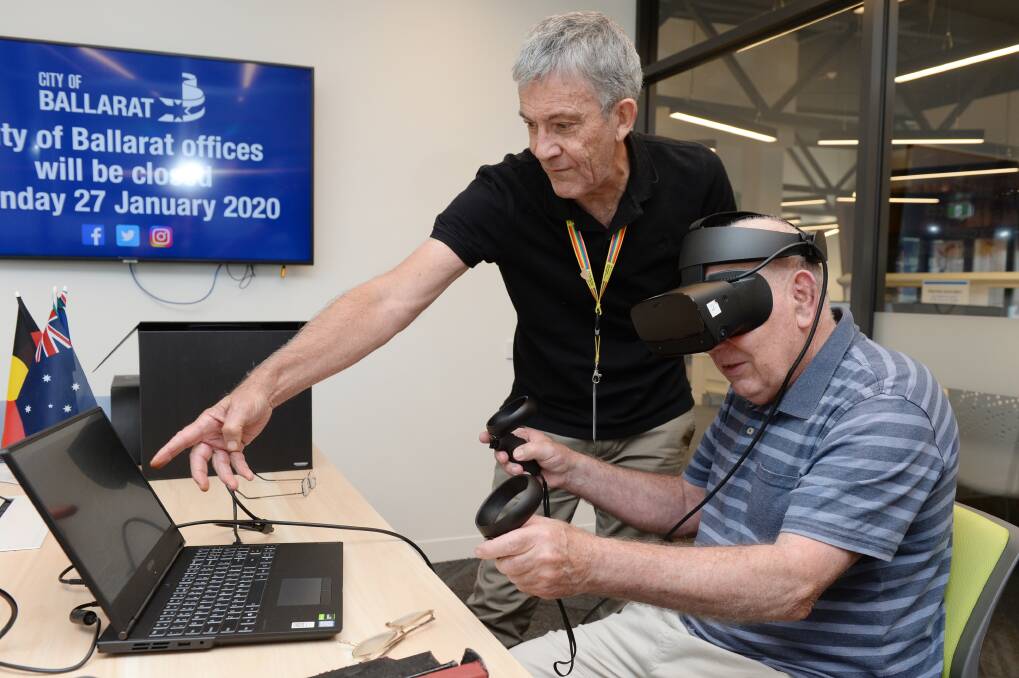 CONNECTION: ICT Training Coordinator Graham Booth helps Jack Cormack from Smythesdale use a virtual reality headset. This opportunity will be available at a night time workshop at Sebastopol Library in February. Picture: Kate Healy 