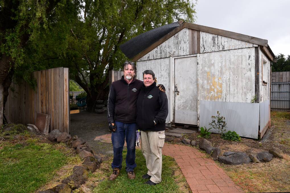 SURVIVORS: Navigators Nursery owners Neville Quick and Lisa Seville were cleaning up damage from the storm on Friday, including metal stopped from the shop roof. Picture: Adam Trafford 