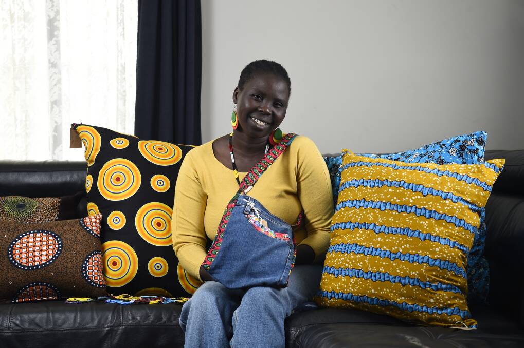 NEW BUSINESS: Nyibol Deng sells handmade products using African material through her business A Tuk. Pictures: Adam Trafford 