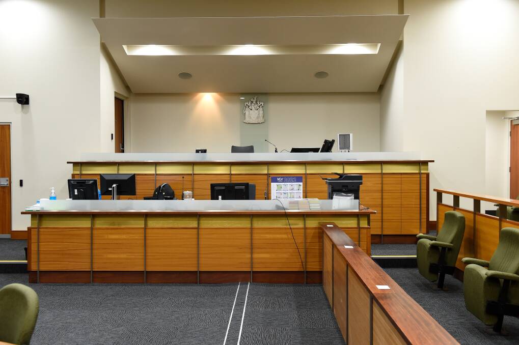 The judge sits on the highest bench in the County Court room in Ballarat. 