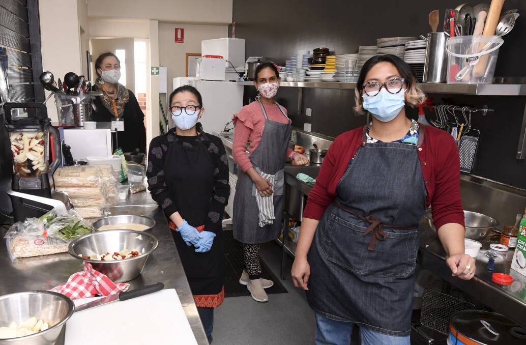 FUN IN THE KITCHEN: A Pot of Courage founder Shiree Pilkinton with cooks Joy Milligan, Stefi Tello and Lilly Wright. Pictures: Lachlan Bence 