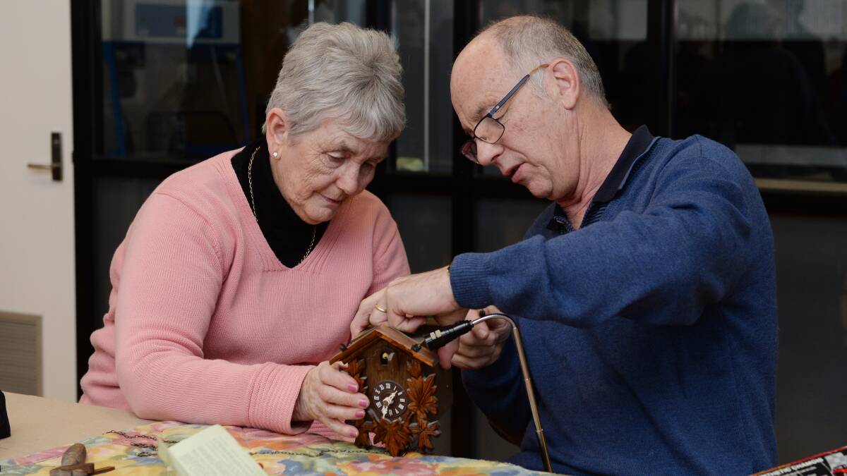 REPAIR: Heather Johnston and Danny Ellis work to fix a cuckoo clock at the Ballarat Repair Cafe. The Repair Cafe is a small scale version of a circular economy. Picture: Kate Healy 