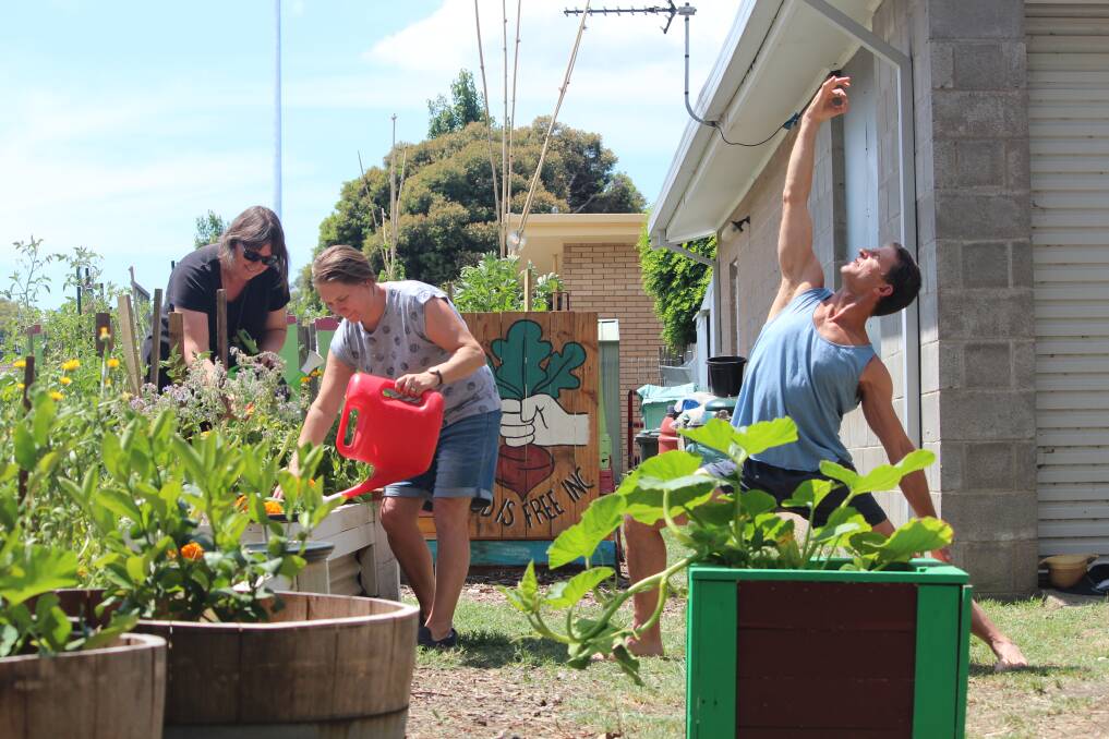 CONNECT: Food is Free founder Lou Ridsdale and committee chair person Ginelle Polanske prepare the garden for 'Yoga Amongst the Carrots with yoga instructor Steve Sedgwick. Picture: Rochelle Kirkham 