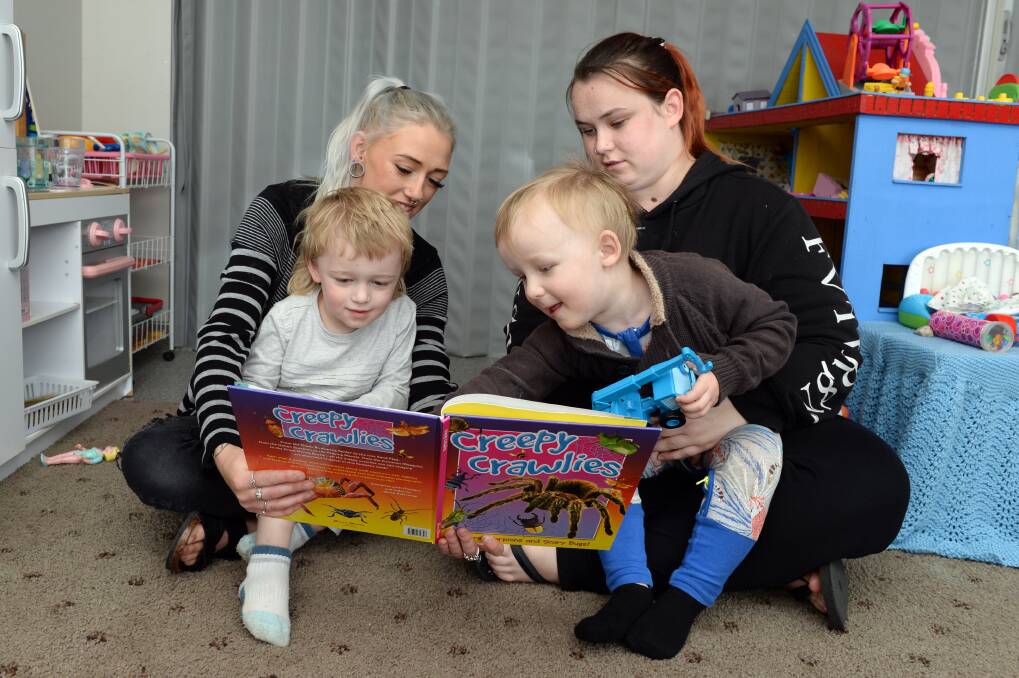 LEARNING: Yuille Park Young Parents Program participants Teagan Fisher, Mayson Fisher, 3, Ashton Nijam, 3, and Chelsea Nijam read a book together. Picture: Kate Healy