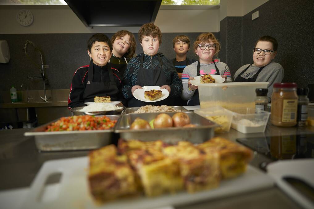 IN THE KITCHEN: Pupils Sebbie, Taj, Joey, Hayley, Chase and Dylan have helped in the kitchen at the farm at Ballarat Specialist School with chef Michelle Hastings who has been making bread and butter pudding. Picture: Luka Kauzlaric 