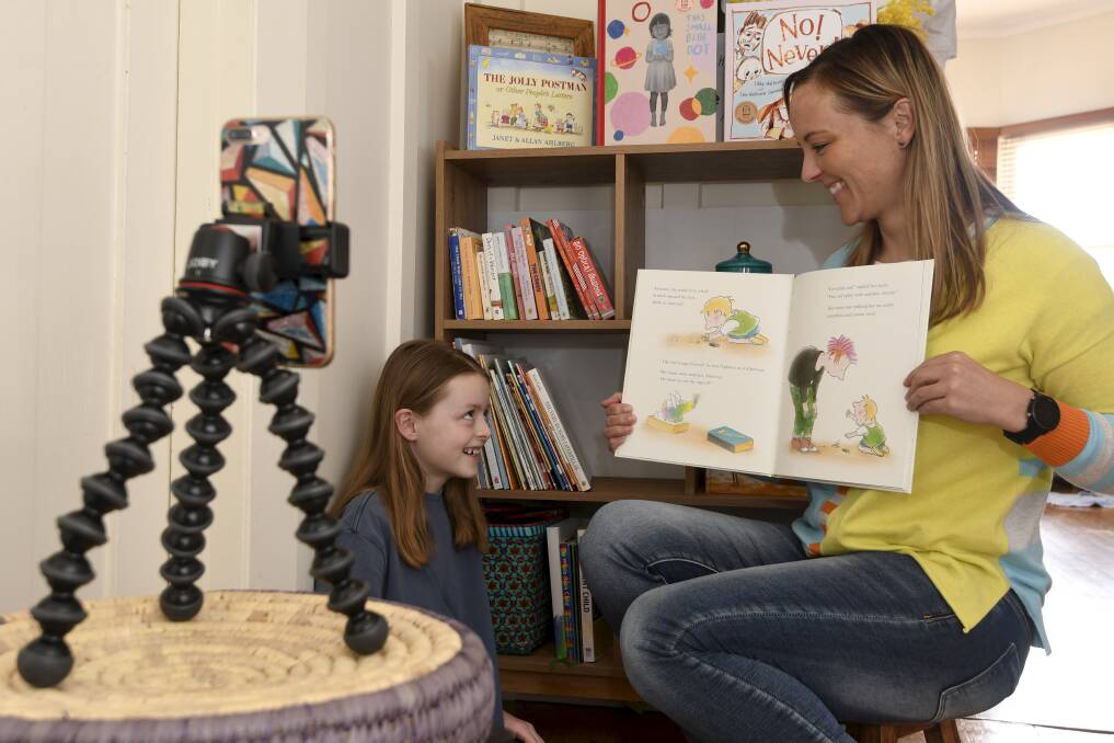 STORY TIME: Ballarat Foundation community engagement and communications coordinator Ricci Shephard reads to her eight-year-old daughter Zoe McGreevy. Picture: Lachlan Bence 