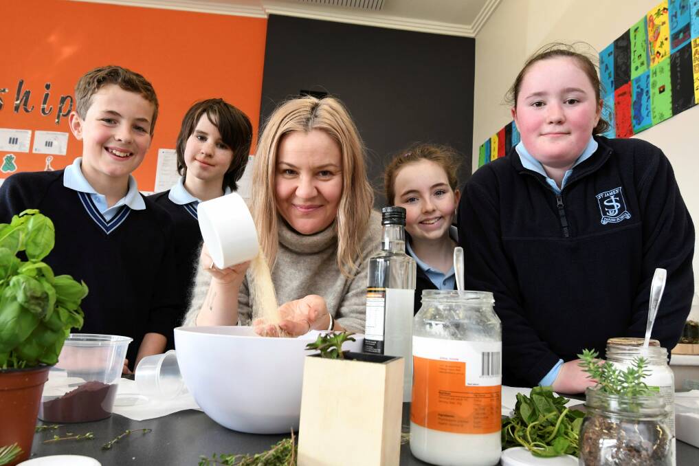 MORE FROM LESS: St James' Parish School pupils Cooper, Rowan, Claudia and Lily learn old fashioned ways to reduce waste from 'granny skills guru' Rebecca Sullivan. Picture: Lachlan Bence 