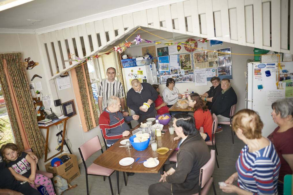 HOT LUNCH: Community members gather in the kitchen to share hot food and conversation. Picture: Luka Kauzlaric