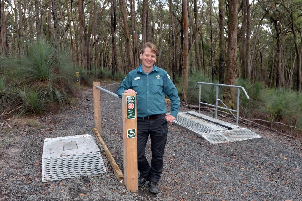 CHANGE: Parks Victoria acting area chief manager Alex Schipperen shows the new cleaning stations as part of changes to Woowookarung Regional Park. Pictures: Kate Healy 
