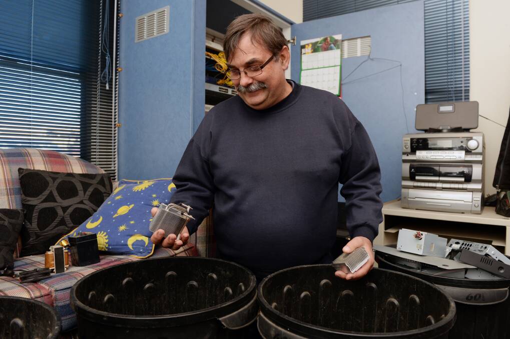 SORT: Flash Drive volunteer Garry Davies sorts computer parts for recycling. 