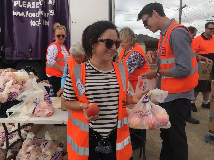 GIVING: Foodbank staff member Melissa Deutscher is one of more than 20 volunteers who handed out produce to clients of Ballarat charities.