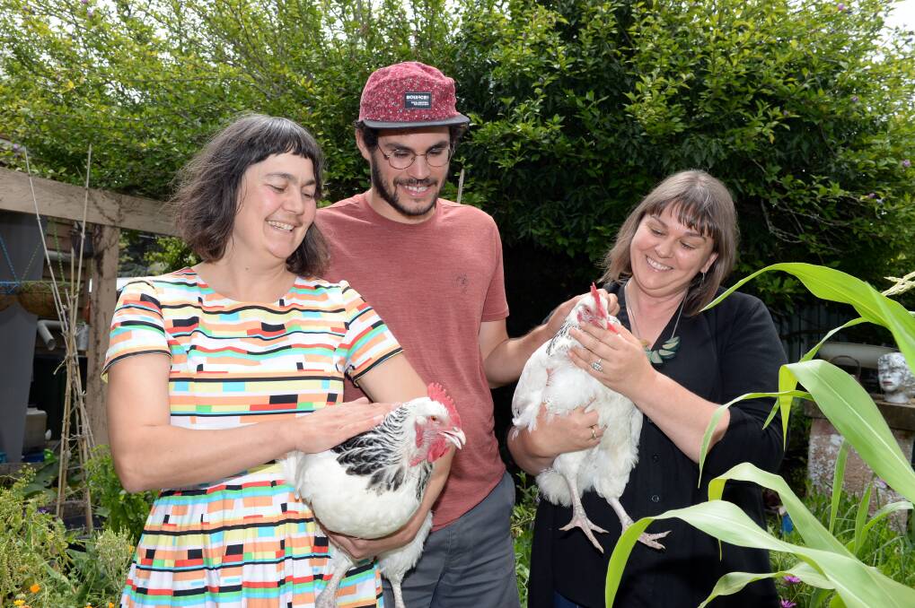 Village Dreaming owner Mara Ripani, Village Dreaming volunteer Alex Fredj and Food Is Free founder Lou Ridsdale promote a workshop on keeping backyard chickens. Picture: Kate Healy 