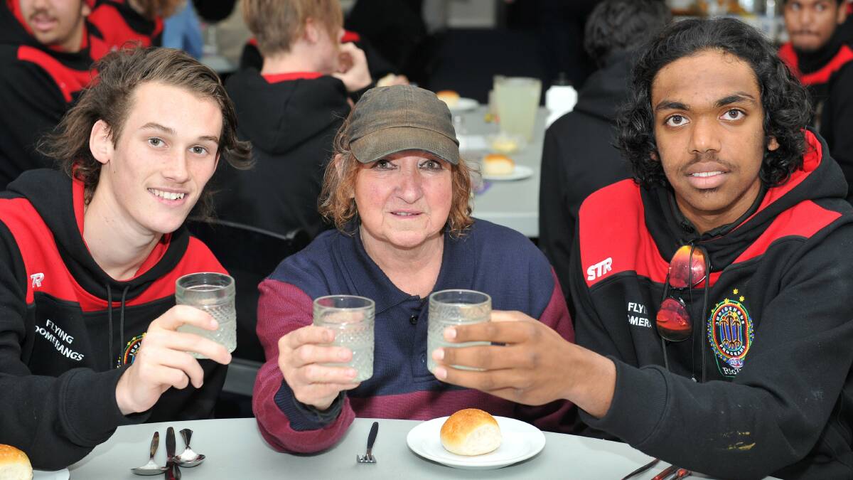 FUTURE TOAST: Lifelong Lions supporter Beverley Jewell with Kobe Knight and Luke Mowaijarlai during yesterday's winter lunch. Photo: Lachlan Bence.
