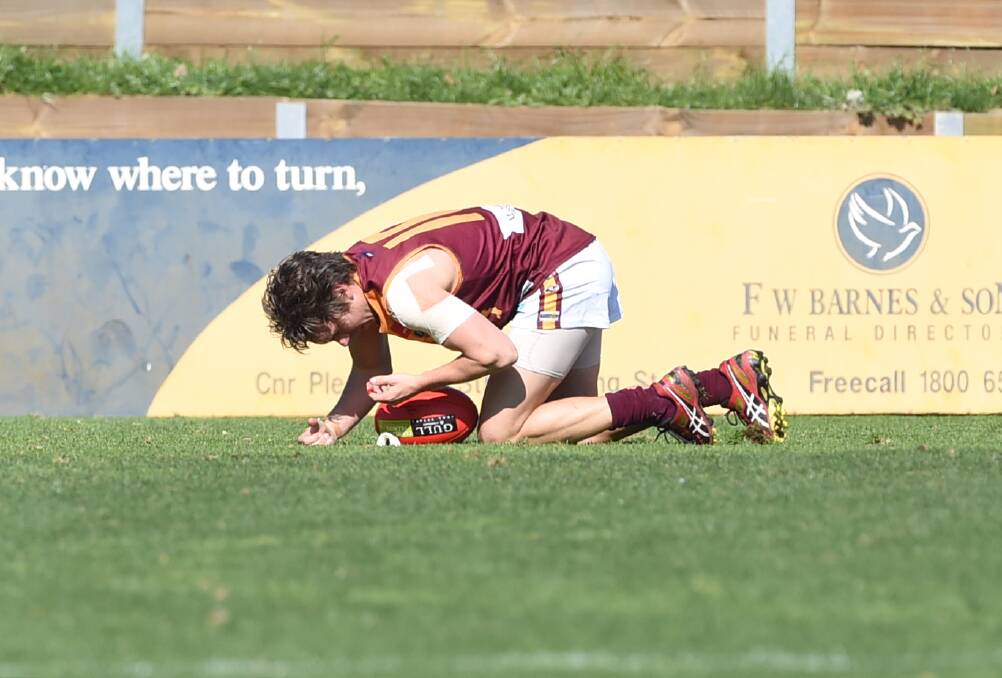 hurt: Redan s Ryan Waight is left with a bleeding nose after a first-quarter incident involving North Ballarat City veteran Marc Greig. PICTURE: Lachlan Bence