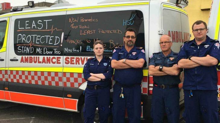 Ambulance officers are using liquid chalk messages to protest against the Baird government.